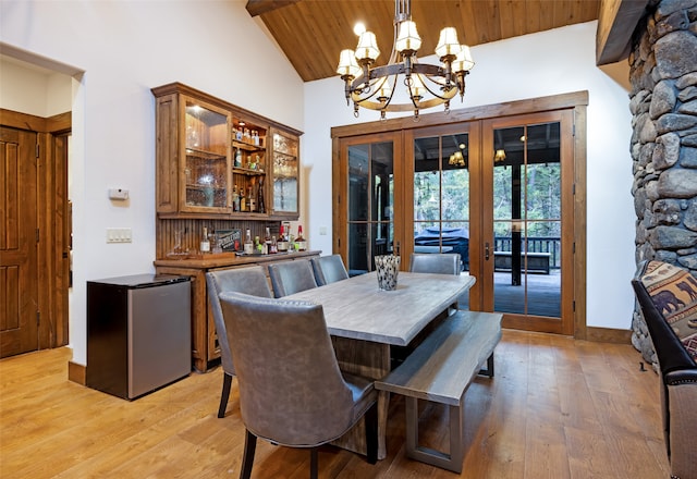 dining area with french doors, wood ceiling, light hardwood / wood-style flooring, and a chandelier