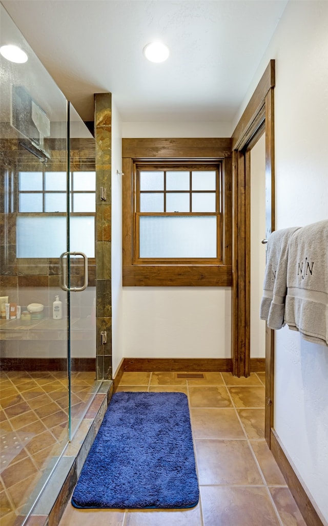 bathroom with an enclosed shower and a wealth of natural light