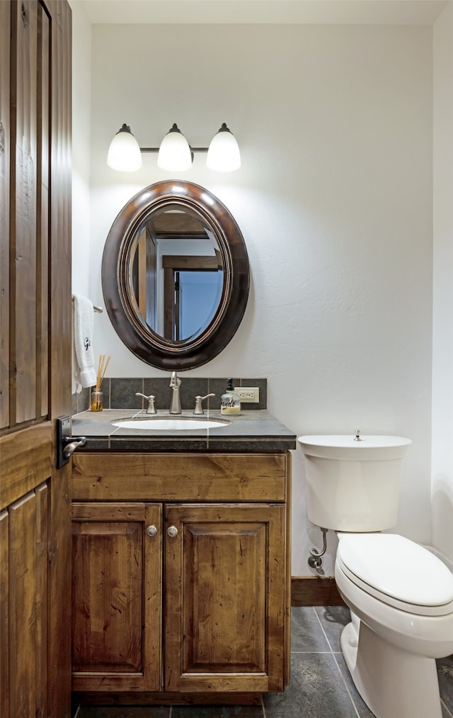 bathroom featuring toilet, vanity, and tile patterned floors