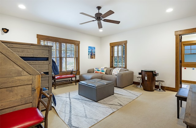 carpeted living room featuring plenty of natural light and ceiling fan