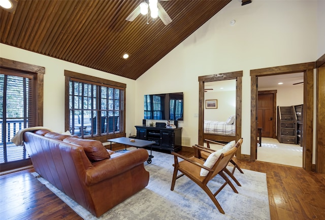 living room with ceiling fan, high vaulted ceiling, wood-type flooring, and wooden ceiling