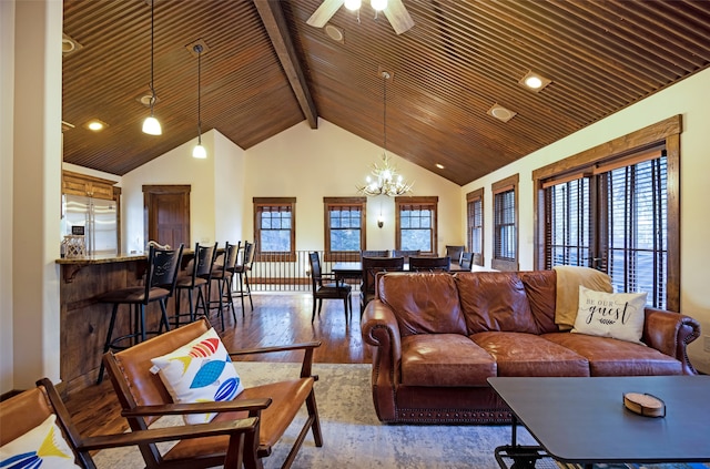 living room featuring a healthy amount of sunlight, hardwood / wood-style floors, ceiling fan with notable chandelier, and high vaulted ceiling