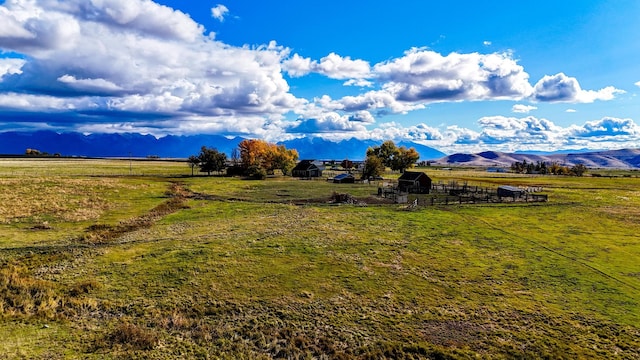 view of yard with a mountain view and a rural view