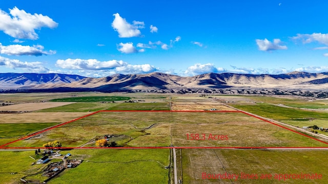 birds eye view of property with a mountain view and a rural view