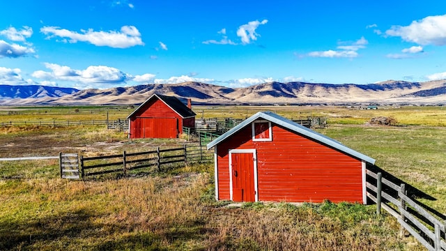 view of outbuilding with a rural view and a mountain view