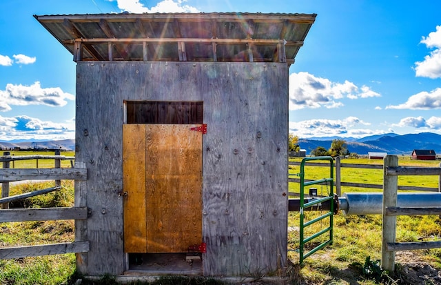 view of outdoor structure featuring a mountain view and a rural view