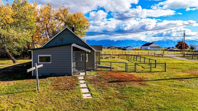 exterior space with a yard and a mountain view