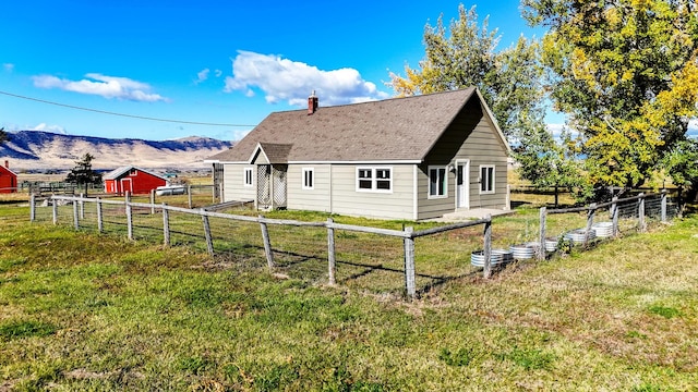 exterior space with a mountain view and a lawn