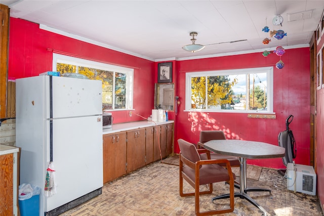 kitchen with heating unit and white refrigerator