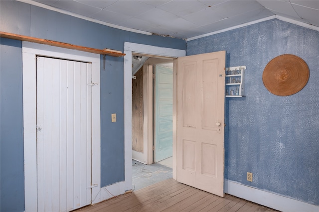 unfurnished bedroom with wood-type flooring and vaulted ceiling