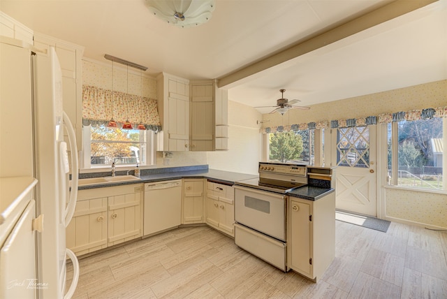 kitchen featuring white appliances, kitchen peninsula, plenty of natural light, and ceiling fan