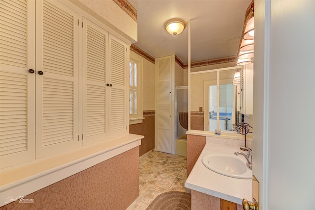 bathroom featuring vanity, a shower with shower door, and tile patterned flooring