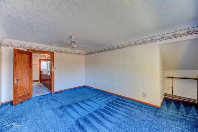 carpeted spare room with ceiling fan, a textured ceiling, and vaulted ceiling