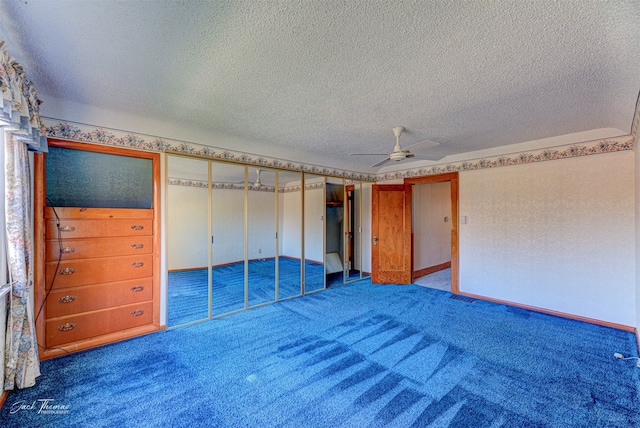 unfurnished bedroom with a closet, a textured ceiling, carpet floors, and ceiling fan