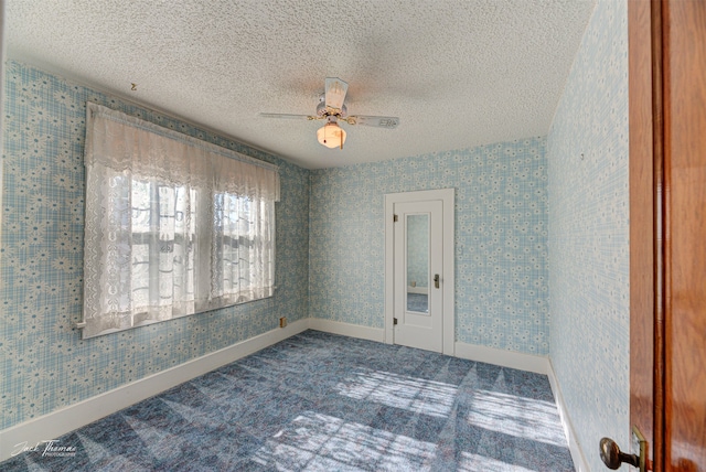 spare room featuring carpet, a textured ceiling, and ceiling fan