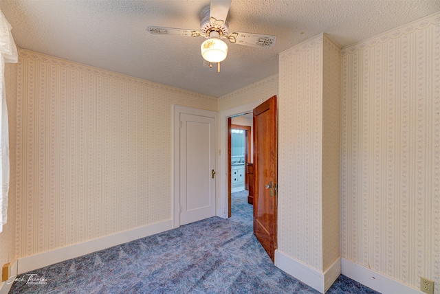 unfurnished room with carpet flooring, a textured ceiling, and ceiling fan