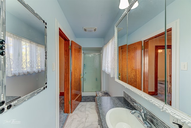 bathroom featuring vanity and a shower with shower door