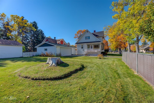 view of yard with a porch and a garage