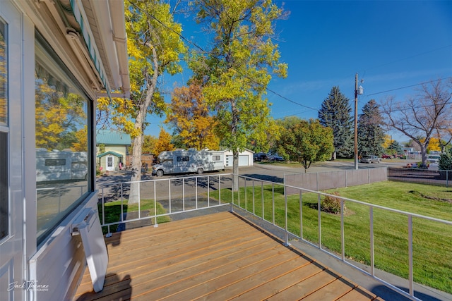 deck with a yard and a garage