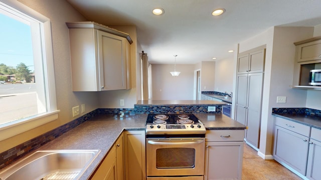 kitchen with tasteful backsplash, sink, kitchen peninsula, pendant lighting, and range with electric stovetop