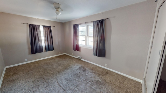 carpeted empty room with ceiling fan