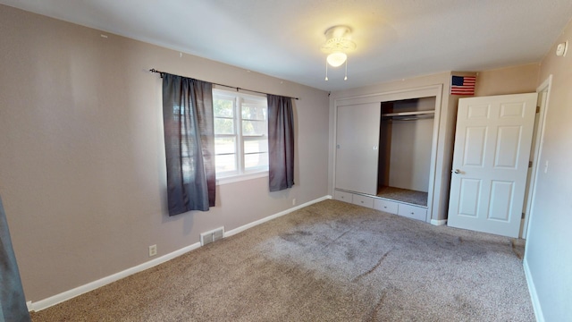 unfurnished bedroom with carpet and a closet