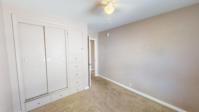 unfurnished bedroom with a closet, light carpet, and ceiling fan