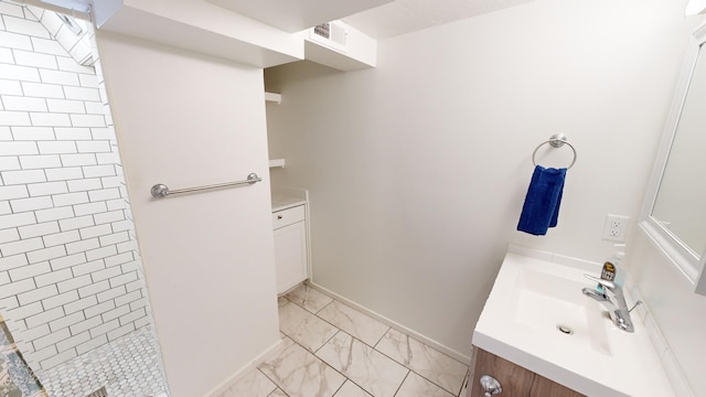 bathroom featuring vanity and tiled shower