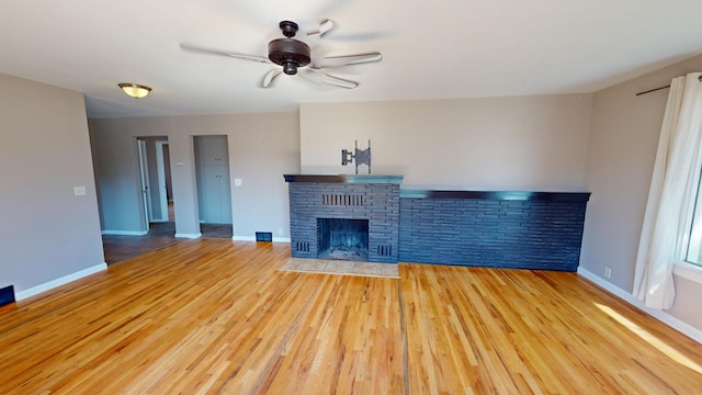 unfurnished living room featuring light hardwood / wood-style flooring, a fireplace, and ceiling fan