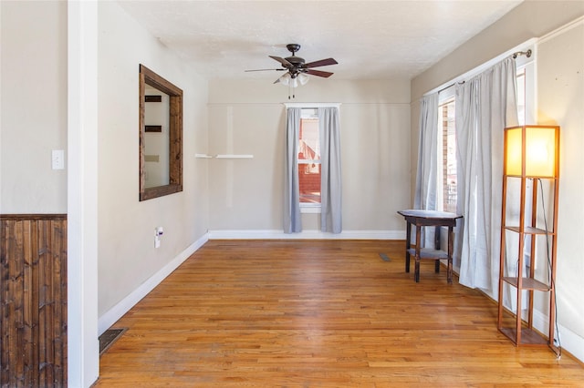 empty room with light hardwood / wood-style floors and ceiling fan