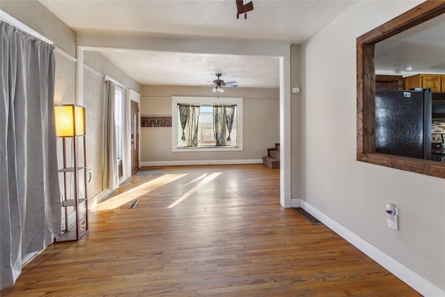 interior space with hardwood / wood-style floors, a textured ceiling, and ceiling fan