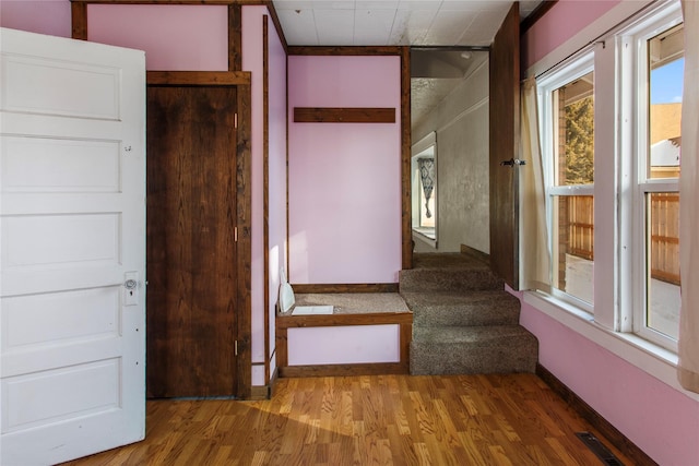 stairs featuring hardwood / wood-style flooring