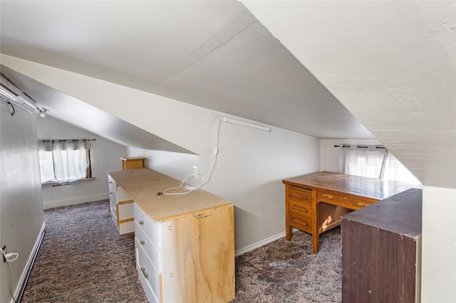 additional living space featuring vaulted ceiling and dark carpet