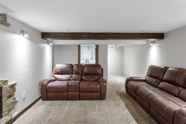 living room featuring beam ceiling and carpet flooring