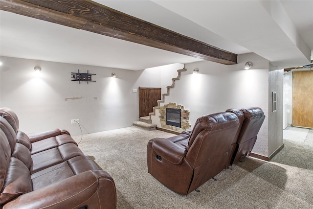 living room featuring beamed ceiling, carpet floors, and a fireplace