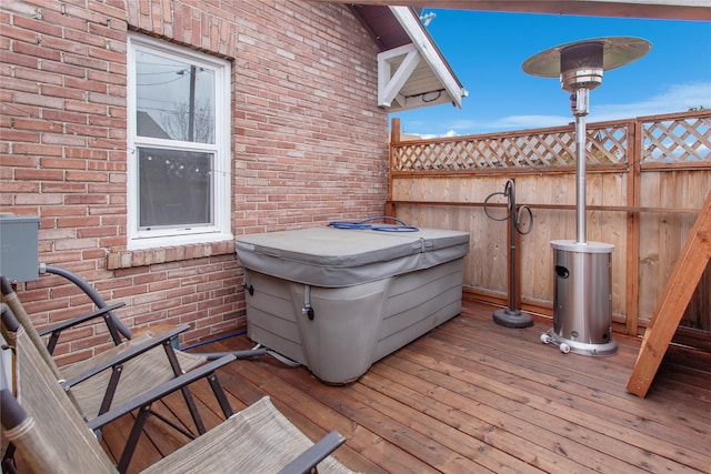 wooden terrace with a hot tub