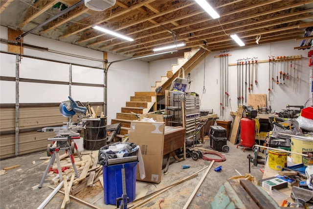 garage with a garage door opener and a workshop area