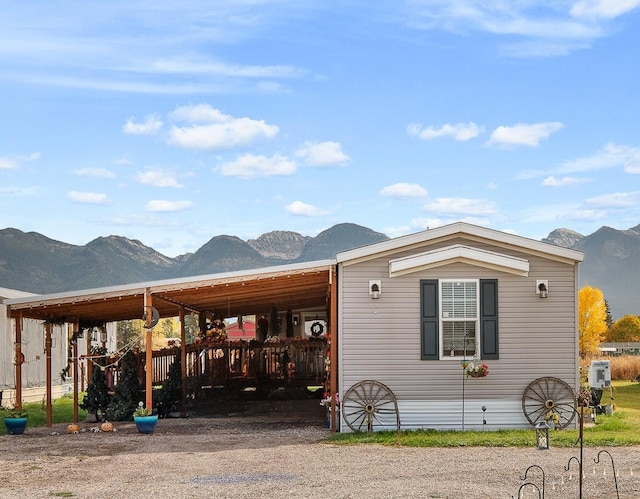 exterior space with a mountain view and a carport