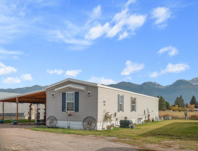 view of property exterior featuring a mountain view and a carport