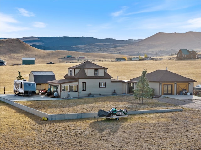 view of front facade featuring a garage and a mountain view