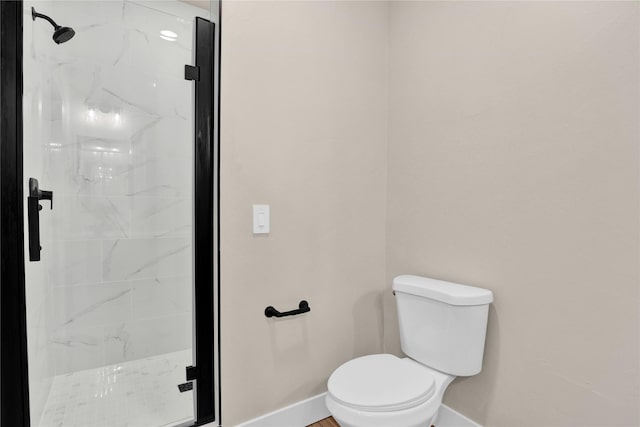 bathroom with toilet and a shower with shower door