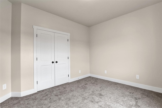 unfurnished bedroom with carpet and a closet