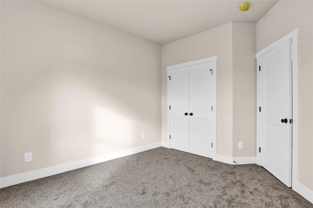 unfurnished bedroom featuring carpet flooring and a closet