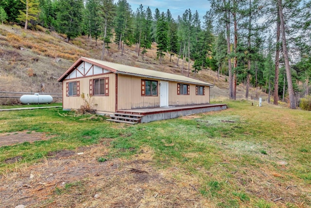20622 US Highway 10 E, Clinton, MT 59825 - view of front of property with a wooden deck, a front yard, and a metal roof