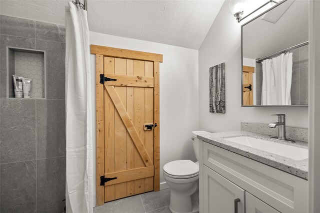 bathroom featuring vanity, toilet, a shower with curtain, and tile patterned flooring