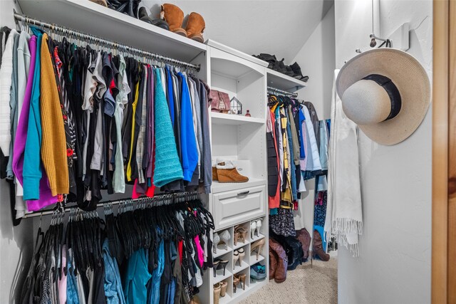 spacious closet with carpet flooring