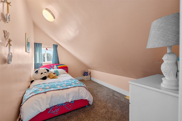 carpeted bedroom featuring lofted ceiling