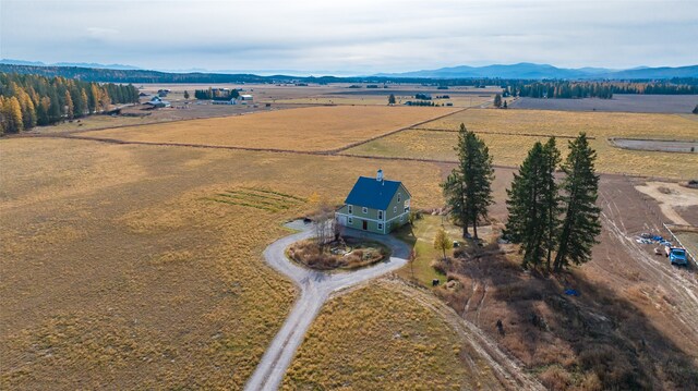 birds eye view of property featuring a mountain view and a rural view