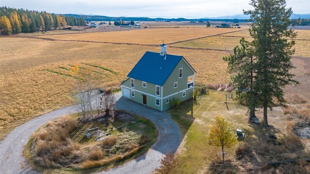 birds eye view of property with a mountain view and a rural view