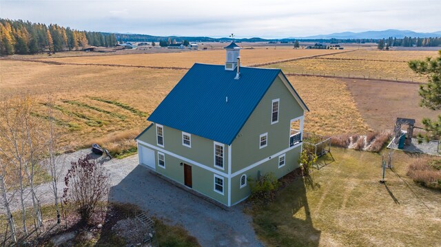 drone / aerial view featuring a mountain view and a rural view